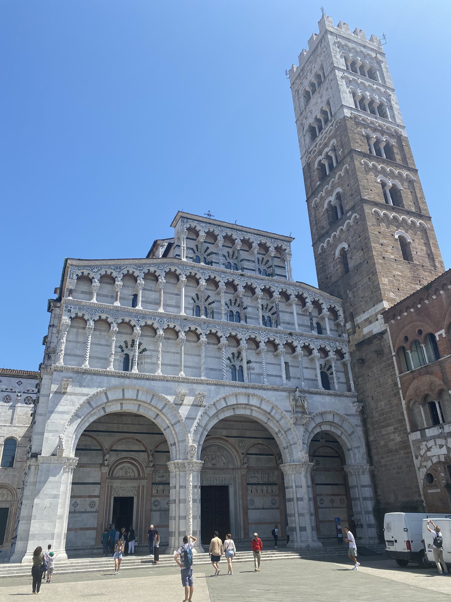 The striped marble facade and bell tower of Lucca's Cattedrale di San Martino